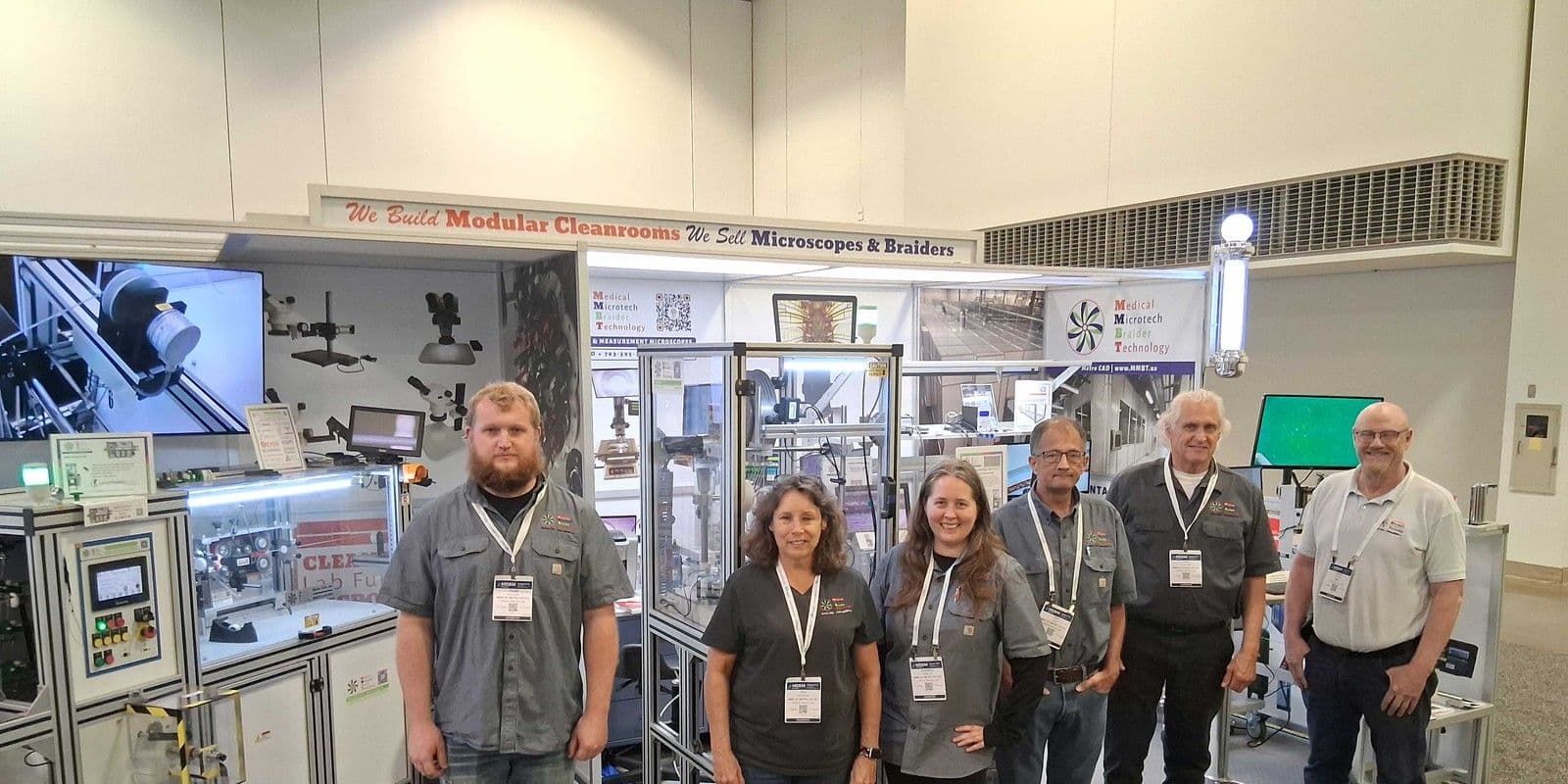MMBT staff at their MD&M Midwest 2025 booth beside cleanroom and braiding equipment