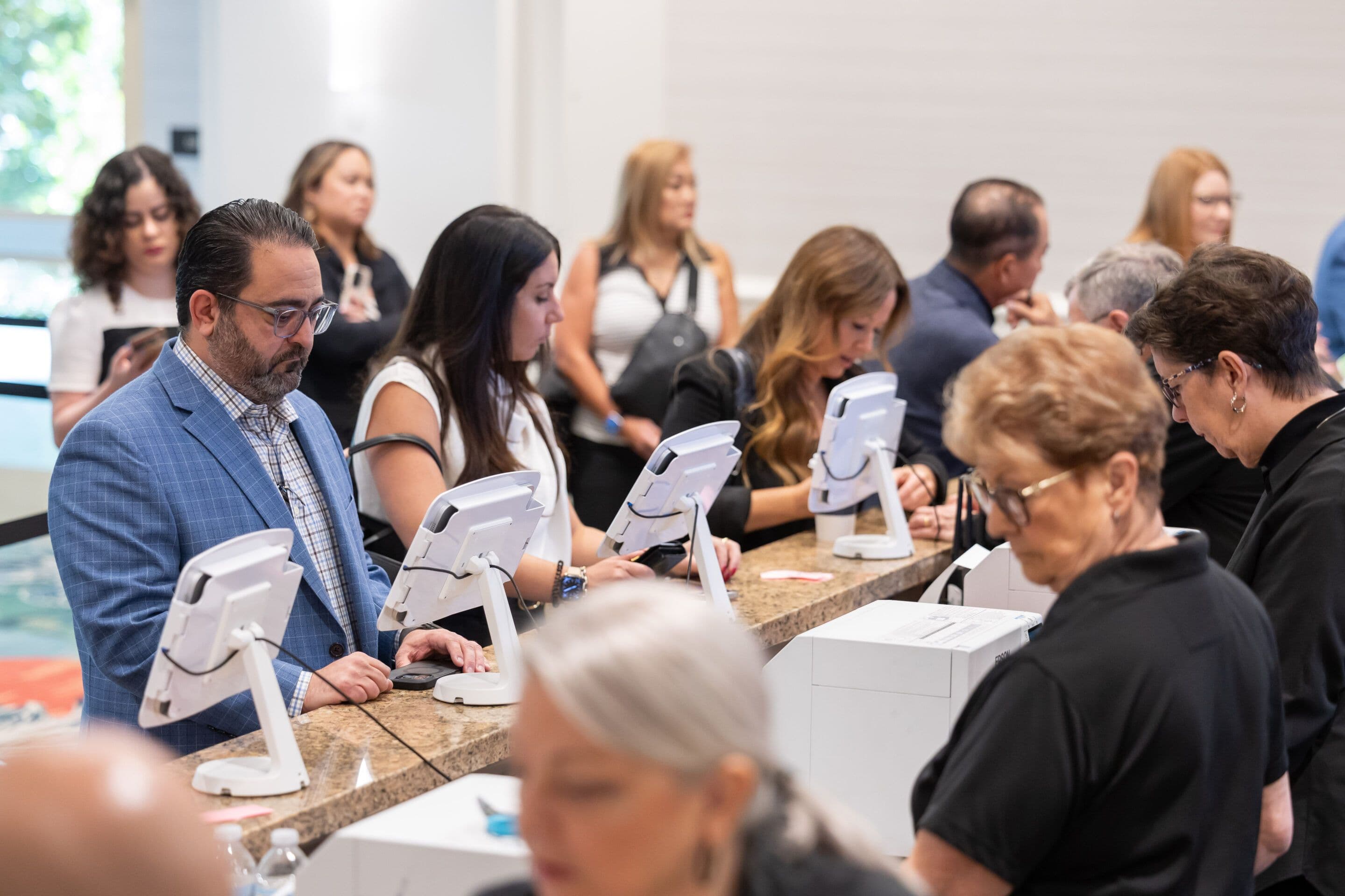 Attendees collecting badges at Digital Dealer Conference and Expo 2025