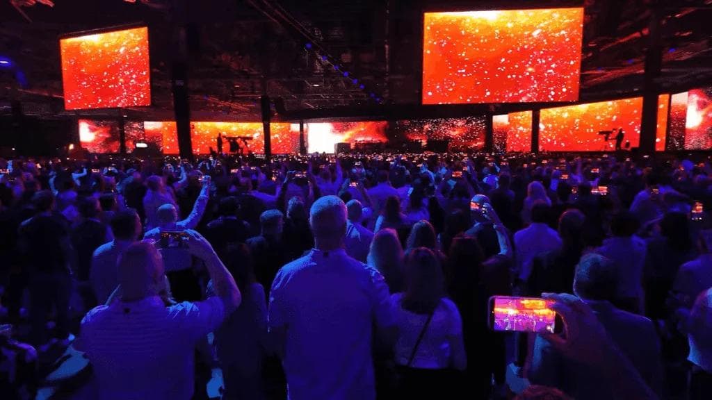 Attendees networking under the Oracle AI World archway in the AI World Hub expo area