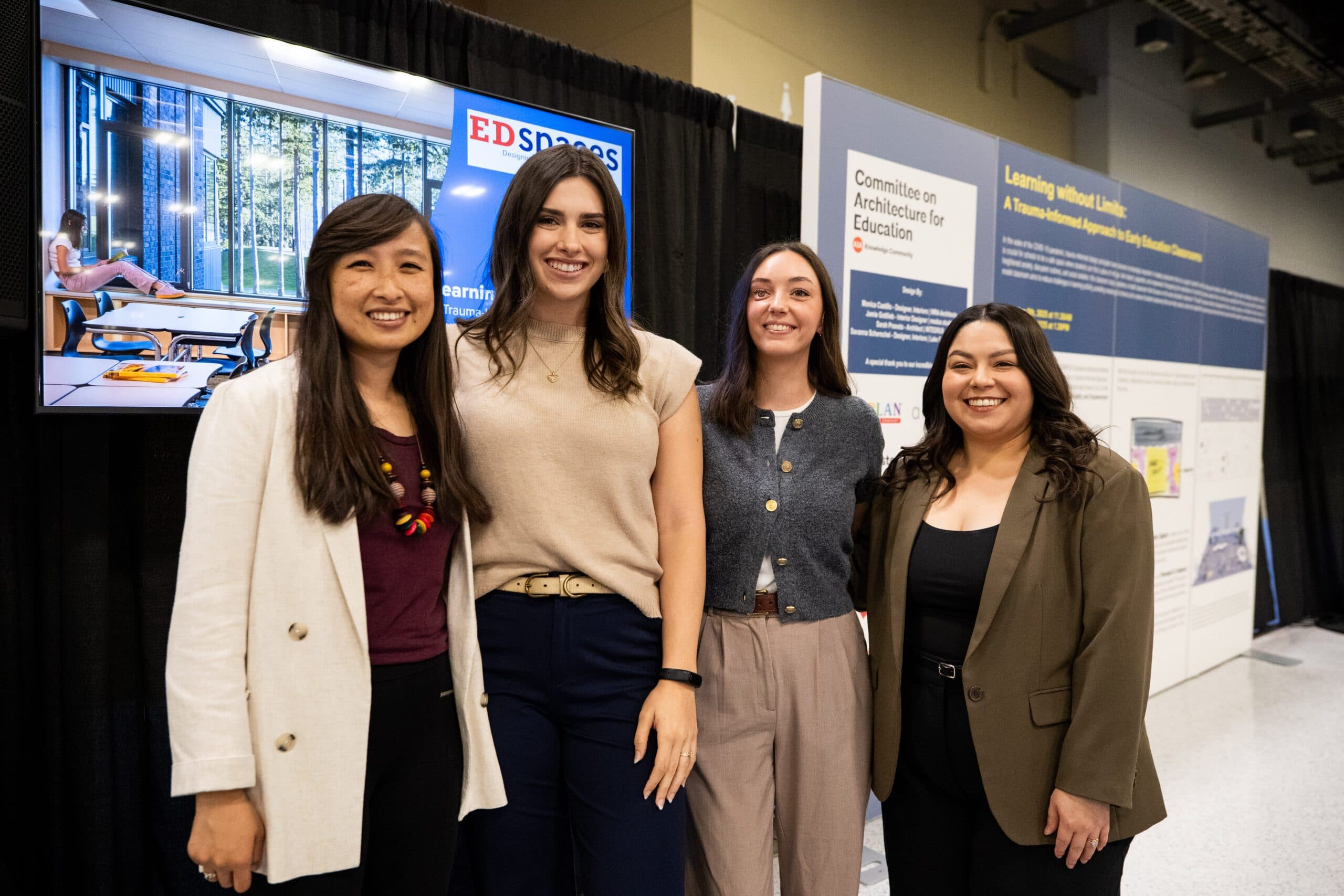 Four design professionals at an EDspaces exhibit display