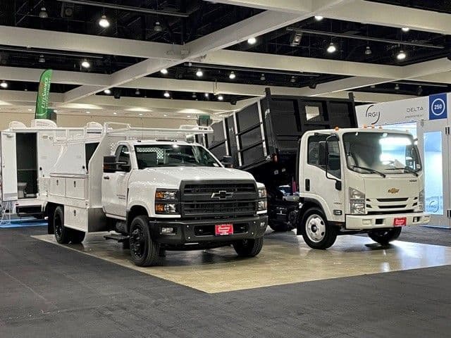 Construction vehicles displayed at an exhibitor booth at the Los Angeles Build Expo.