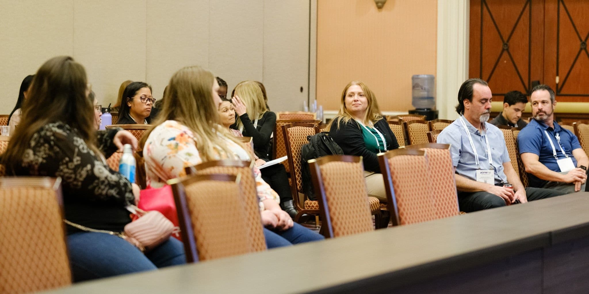Conference participants seated around a table at IOFM Fall 2024.