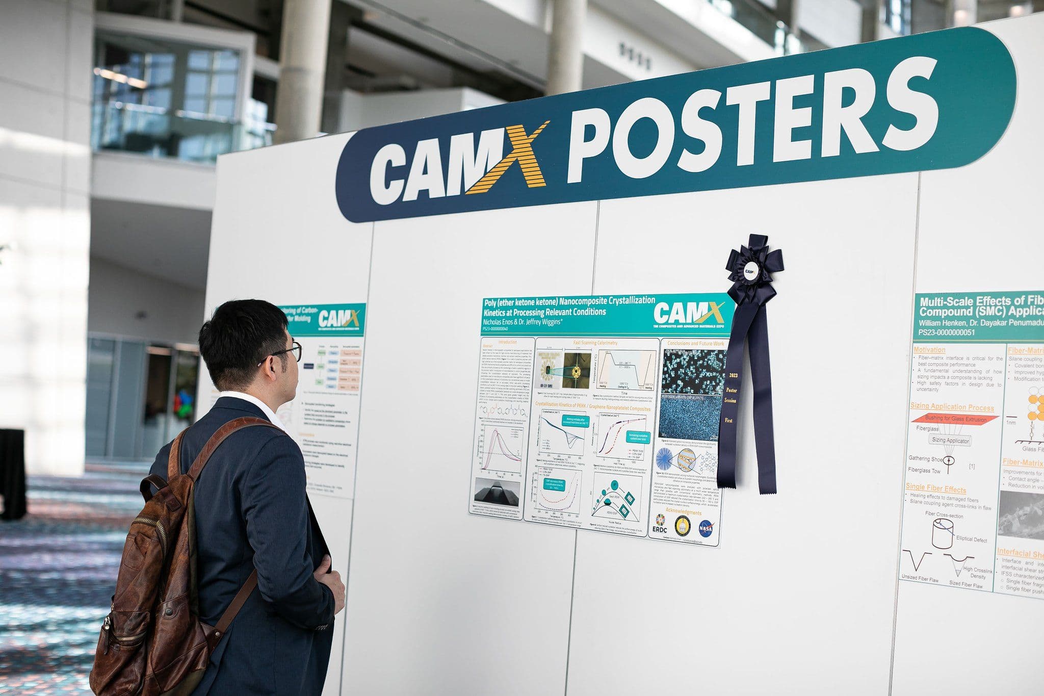 Attendees review technical posters at CAMX 2023 in Atlanta