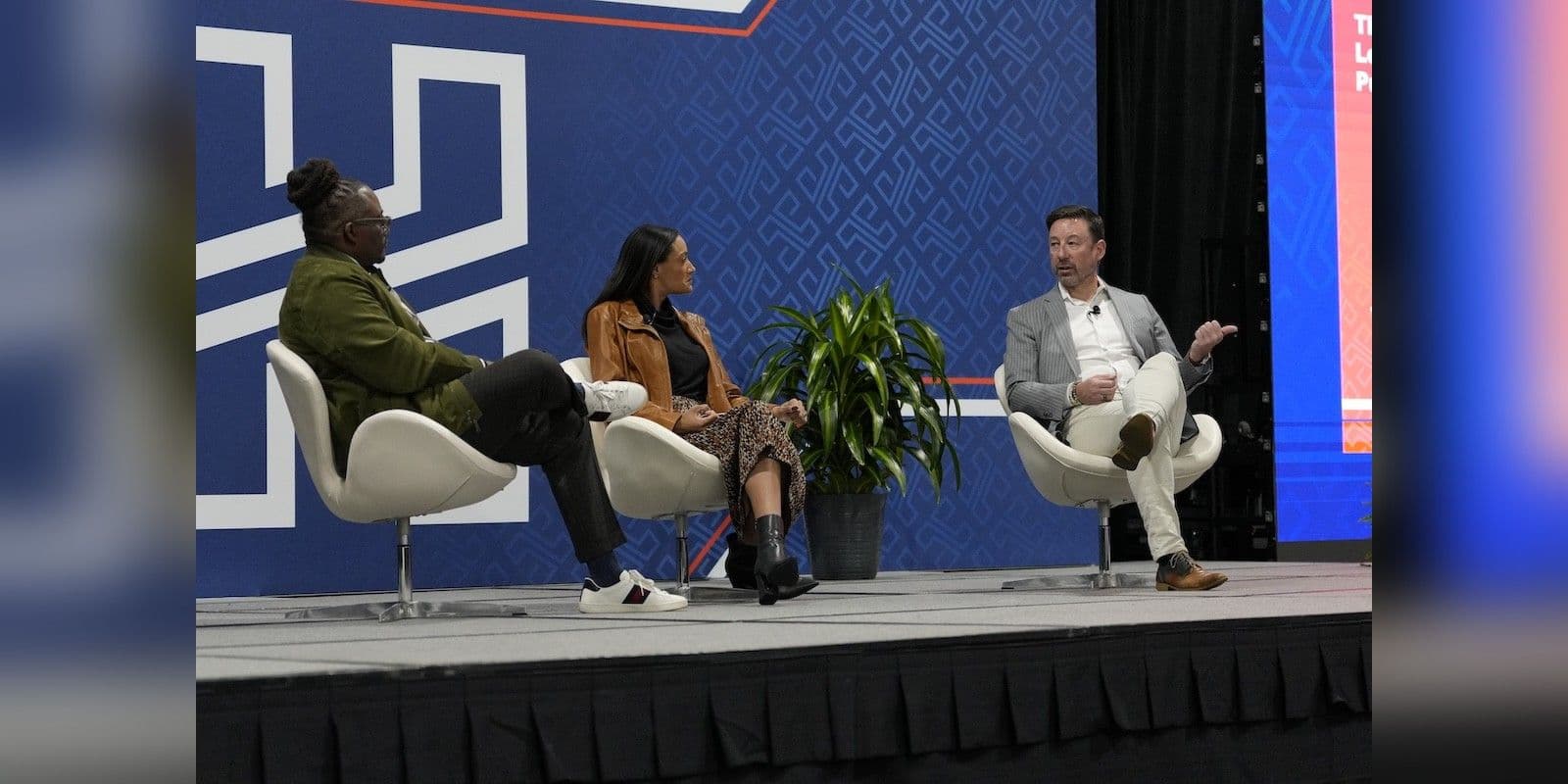 Three speakers discussing hotel leadership on stage at The Hospitality Show 2025