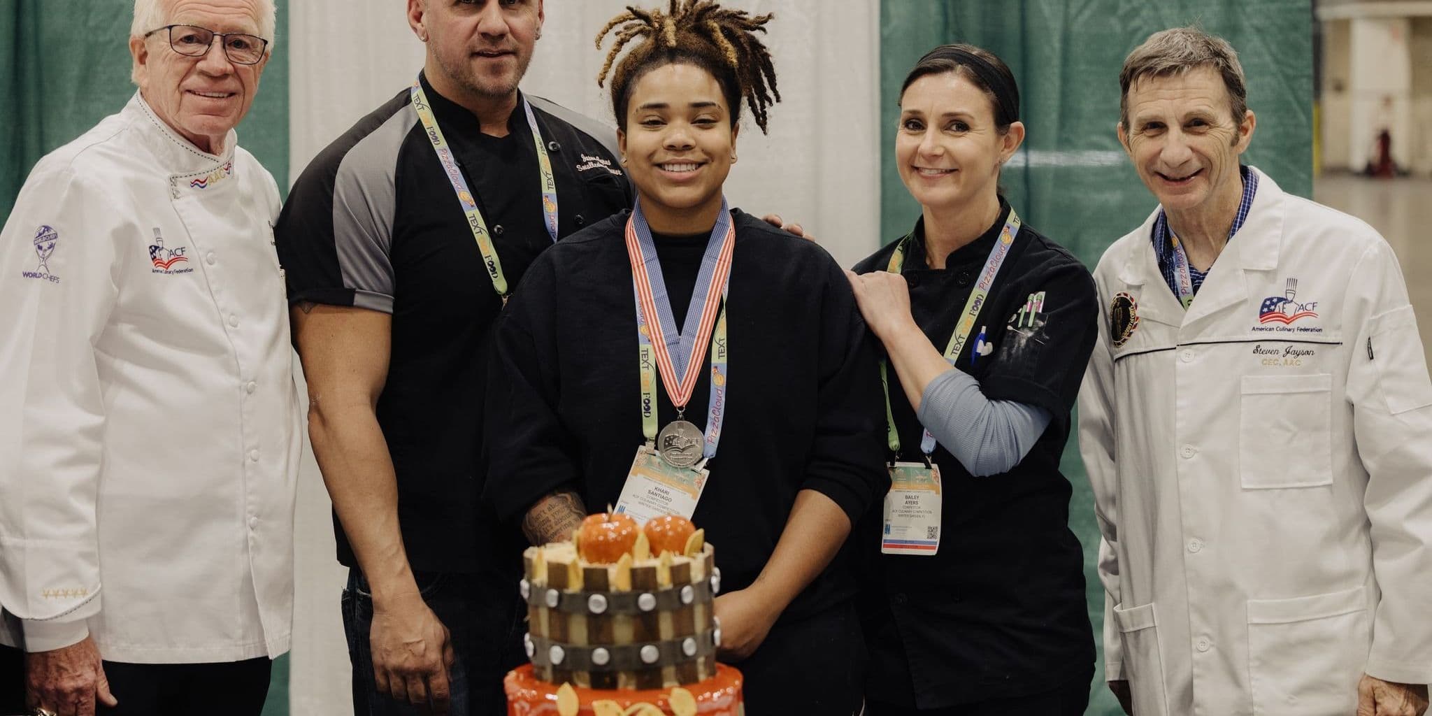 Chefs and an award recipient at a Florida Restaurant Show culinary competition.