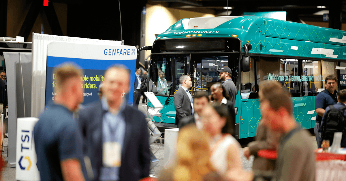 Electric bus display and attendees in the expo hall