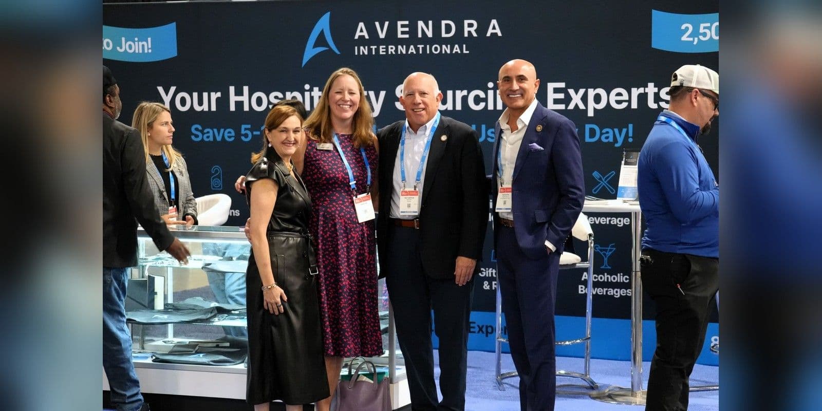 Four hospitality professionals at the Avendra International booth in 2025