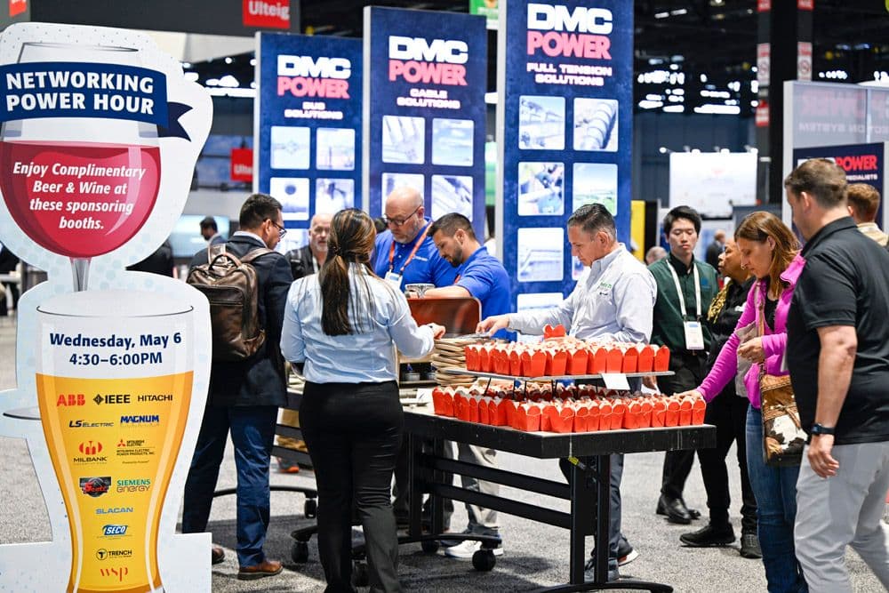IEEE PES T&D 2026 attendees gathering at a Power Hour station on the exhibit floor