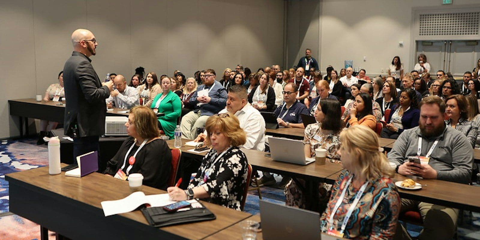 A speaker addresses contact center professionals during an ICMI conference session.