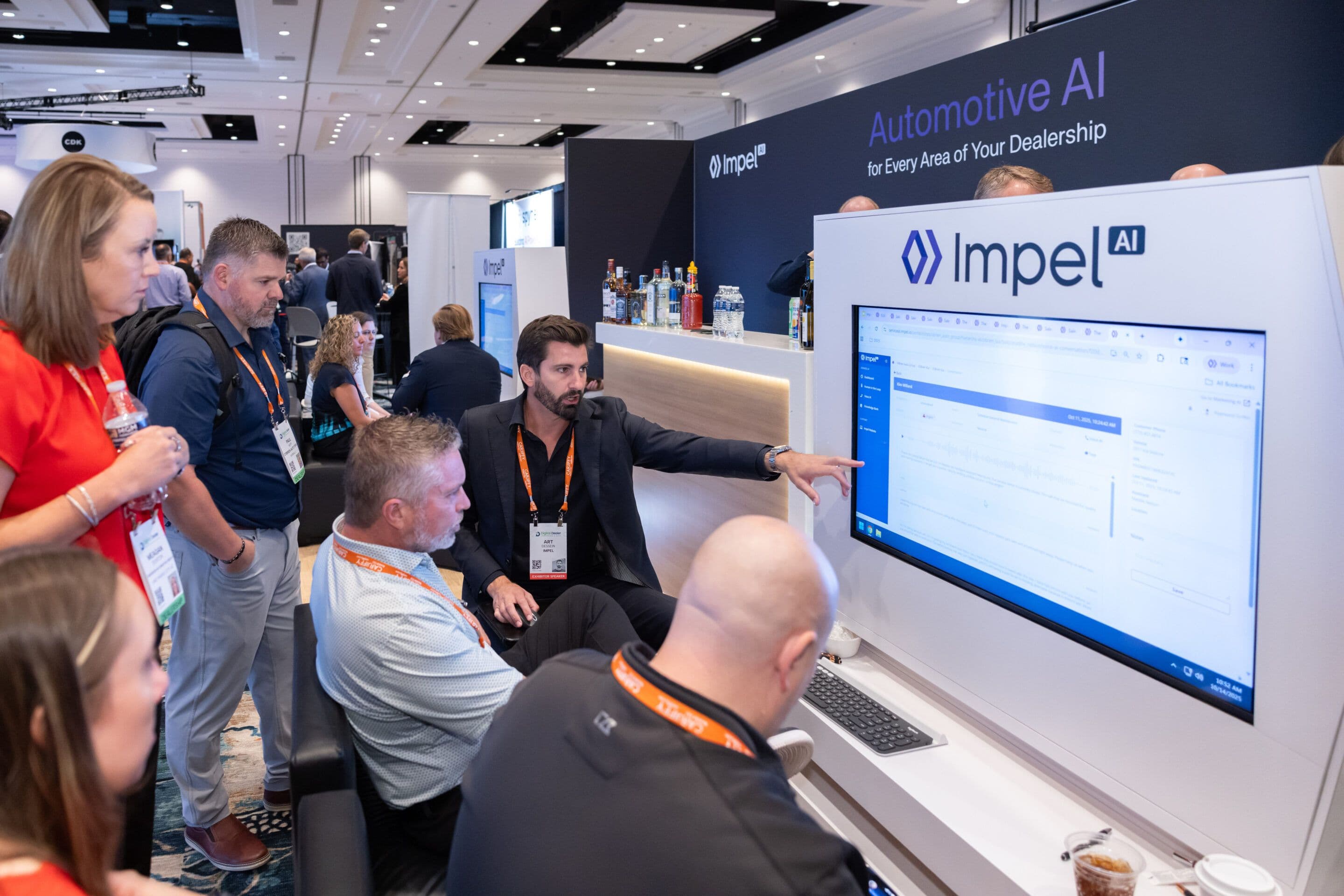 Impel team demonstrating dealership technology on the Digital Dealer 2025 expo floor